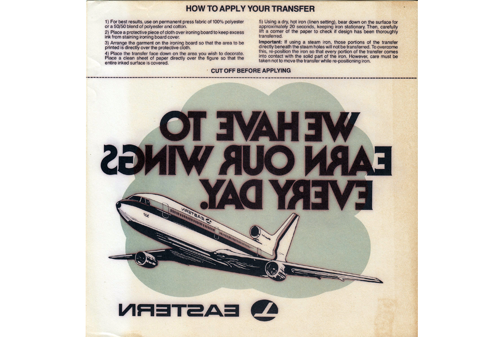 Reverse glass transfer with picture of plane. Transfer says We Have To Earn Our Wings Every Day